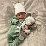 newborn, baby, sleeping, plush_toy, elephant, hat, onesie, blanket, cozy, infant, cute, soft, peaceful, child, clothing, indoors, resting, hand, footed_pajamas, adorable