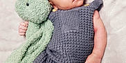 Zayvian is registered to the contest to win money with this photo: baby, infant, plush_toy, knitted_clothing, gray_outfit, green_bunny, blanket, soft_texture, cute, lying_down, child, newborn, cozy, portrait, indoors, hand, face, eyes, expression, resting