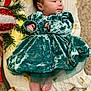 baby, velvet_dress, blanket, golden_hearts, christmas_decoration, greenery, infant, foot, hand, face, curly_hair, carpet, indoors, plush, cute, holiday, decor, portrait, child, soft