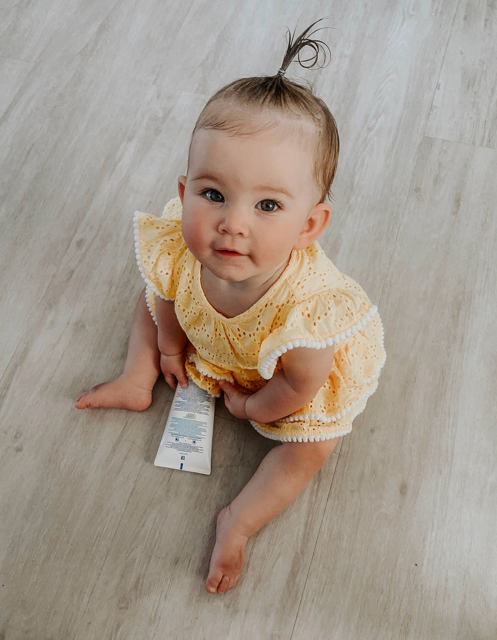 Meelah is registered to the contest to win money with this photo: baby, cheek, child, child_model, dress, eye, face, floor, flooring, hand, head, iris, leg, person, photograph, photography, sitting, skin, textile, toddler