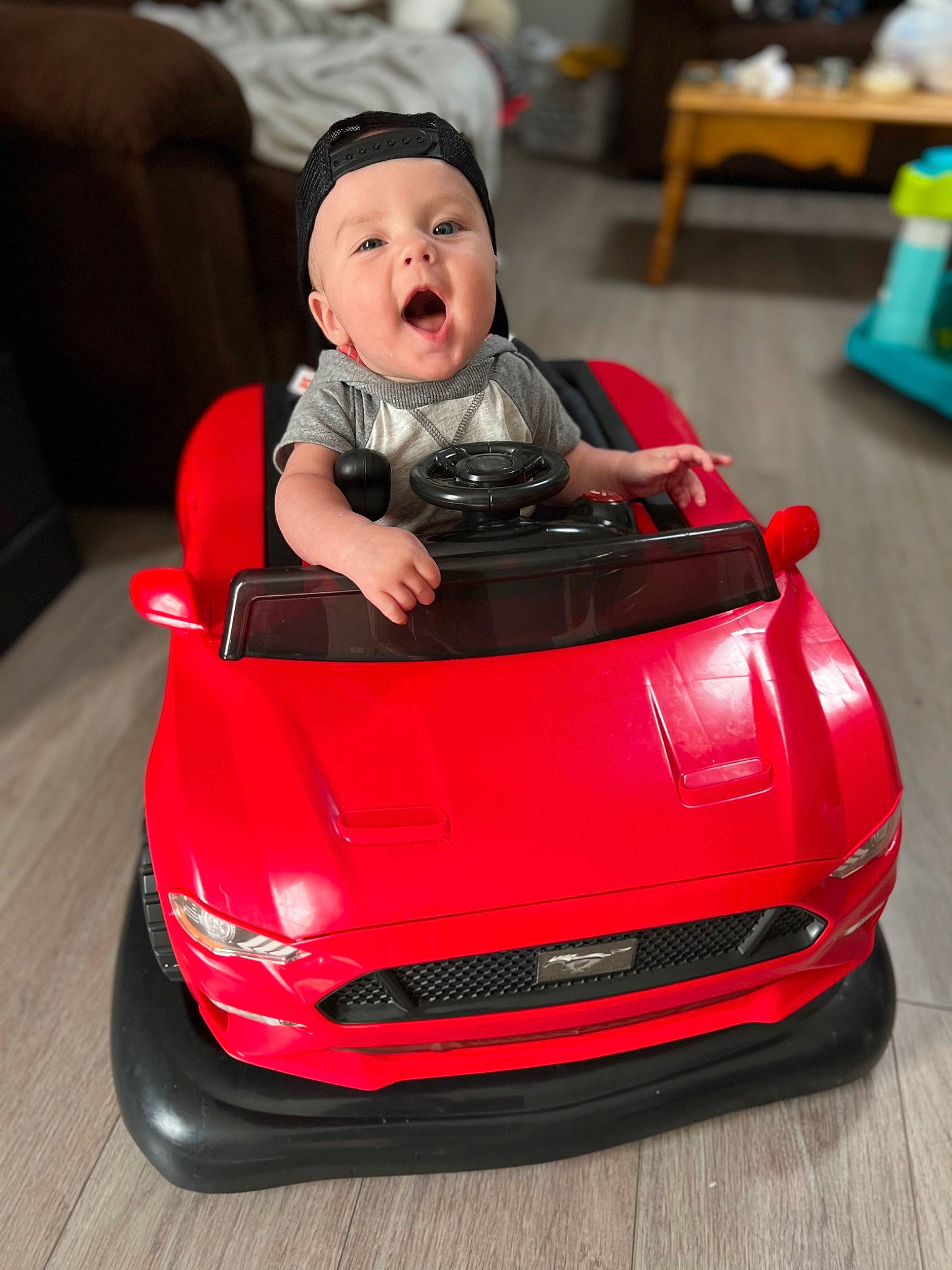 Kannon is registered to the contest to win money with this photo: auto_part, automotive_design, automotive_exterior, automotive_lighting, automotive_wheel_system, baby, bumper, car, chair, green, grille, headlamp, headwear, hood, motor_vehicle, person, personal_luxury_car, red, toddler, toy