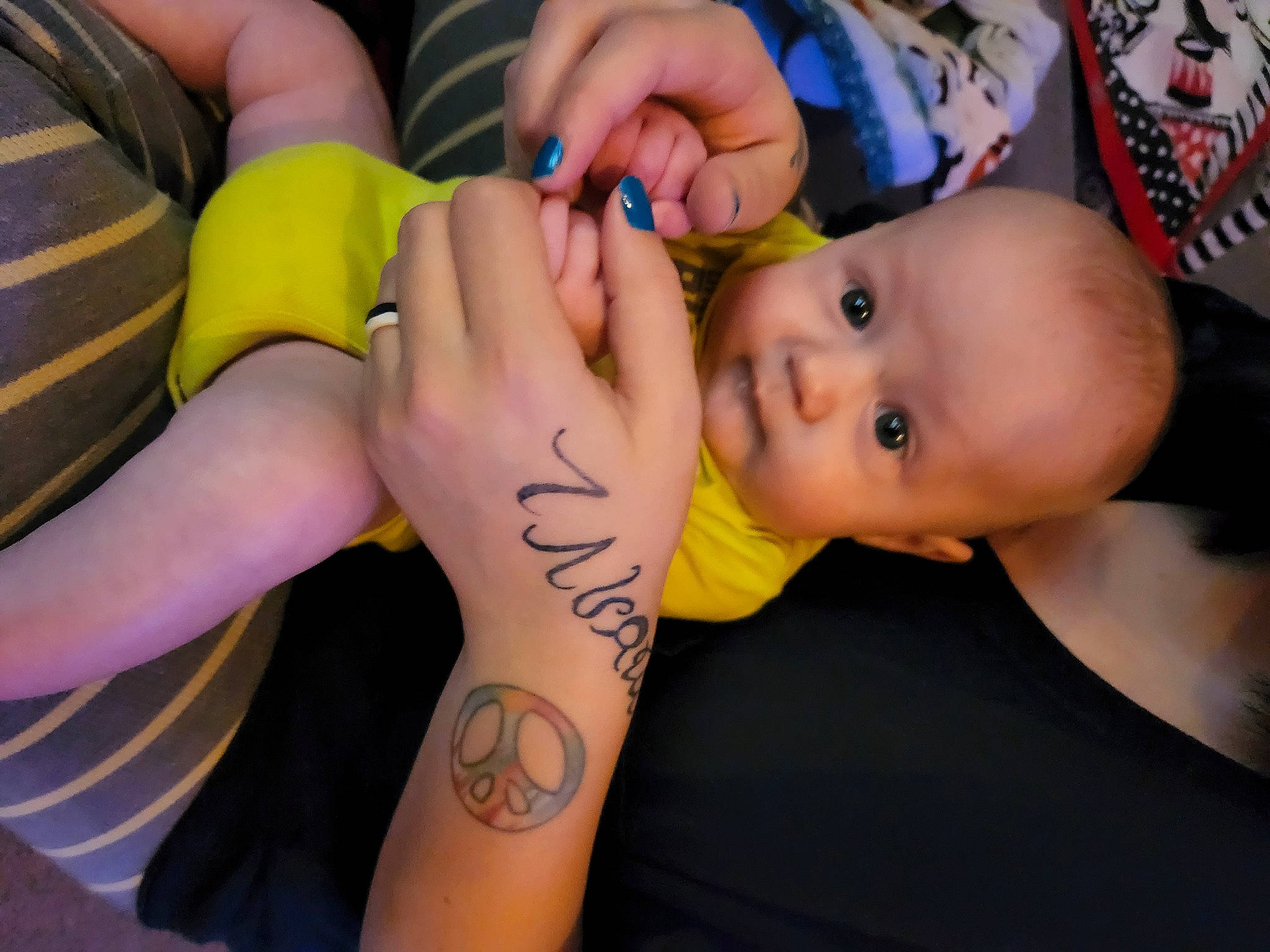 Corey is registered to the contest to win money with this photo: arm, baby, child, elbow, eyelash, finger, gesture, hand, happy, human_leg, joint, knee, nail, pattern, person, skin, temporary_tattoo, thigh, thumb, toddler