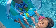 Ellamay is registered to the contest to win money with this photo: baby, child, pool, water, float, swimming, sunshade, blue, smile, happy, summer, fun, outdoor, safety, infant, toddler, sibling, play, swimwear, family