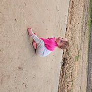 Journey is registered to the contest to win money with this photo: beach, child, concrete, fun, grass, landscape, leisure, magenta, plant, play, recreation, shadow, sitting, sky, soil, toddler, tree, trunk, vacation, wood