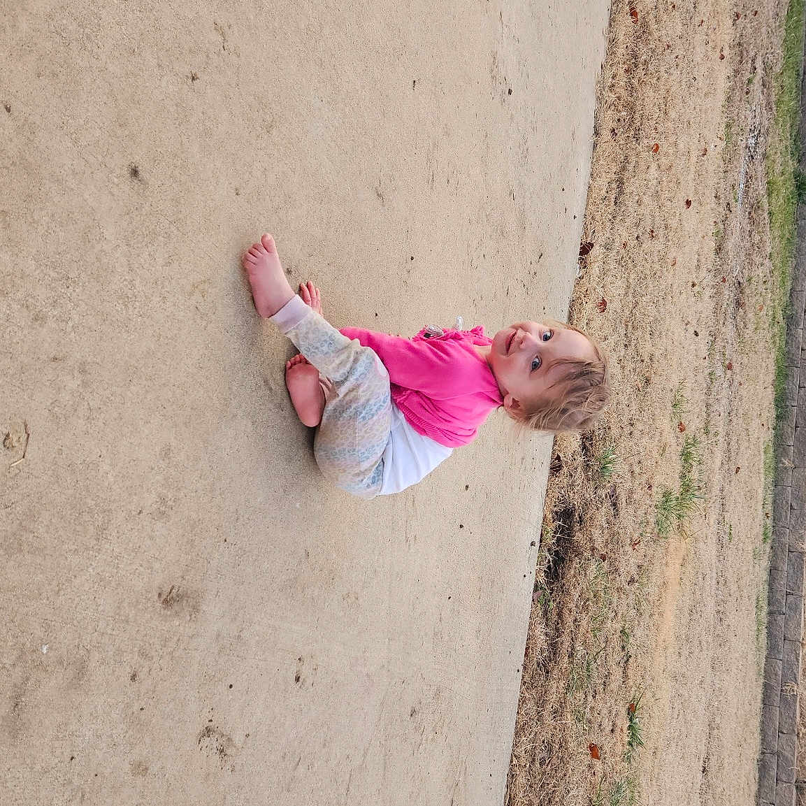 Journey is registered to the contest to win money with this photo: beach, child, concrete, fun, grass, landscape, leisure, magenta, plant, play, recreation, shadow, sitting, sky, soil, toddler, tree, trunk, vacation, wood