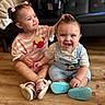 toddler, baby, child, indoor, floor, smiling, sitting, hair, shoes, clothing, cute, happy, person, playful, candid, family, home, wooden_floor, interior, bonding