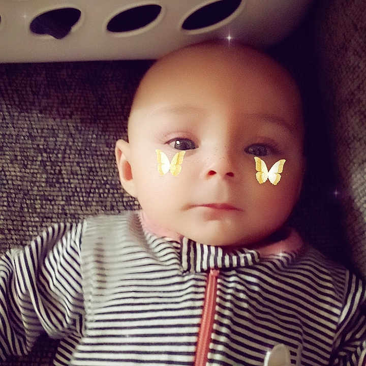Kaylee is registered to the contest to win money with this photo: baby, clothing, coat, couch, cushion, face, furniture, hat, head, homedecor, hood, hoodie, jacket, knitwear, person, photography, portrait, sweater, sweatshirt, toy