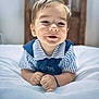 baby, child, smiling, portrait, indoor, bed, white_bedspread, striped_clothing, blue_clothing, hands, face, head, hair, happy, cute, infant, young_child, wooden_headboard, soft_texture, lying_down