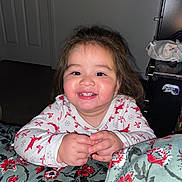 Asly is registered to the contest to win money with this photo: child, toddler, smiling, happy, face, hands, clothing, long_hair, indoor, blanket, floral_pattern, bedroom, door, furniture, nightwear, person, cute, portrait, playful, young