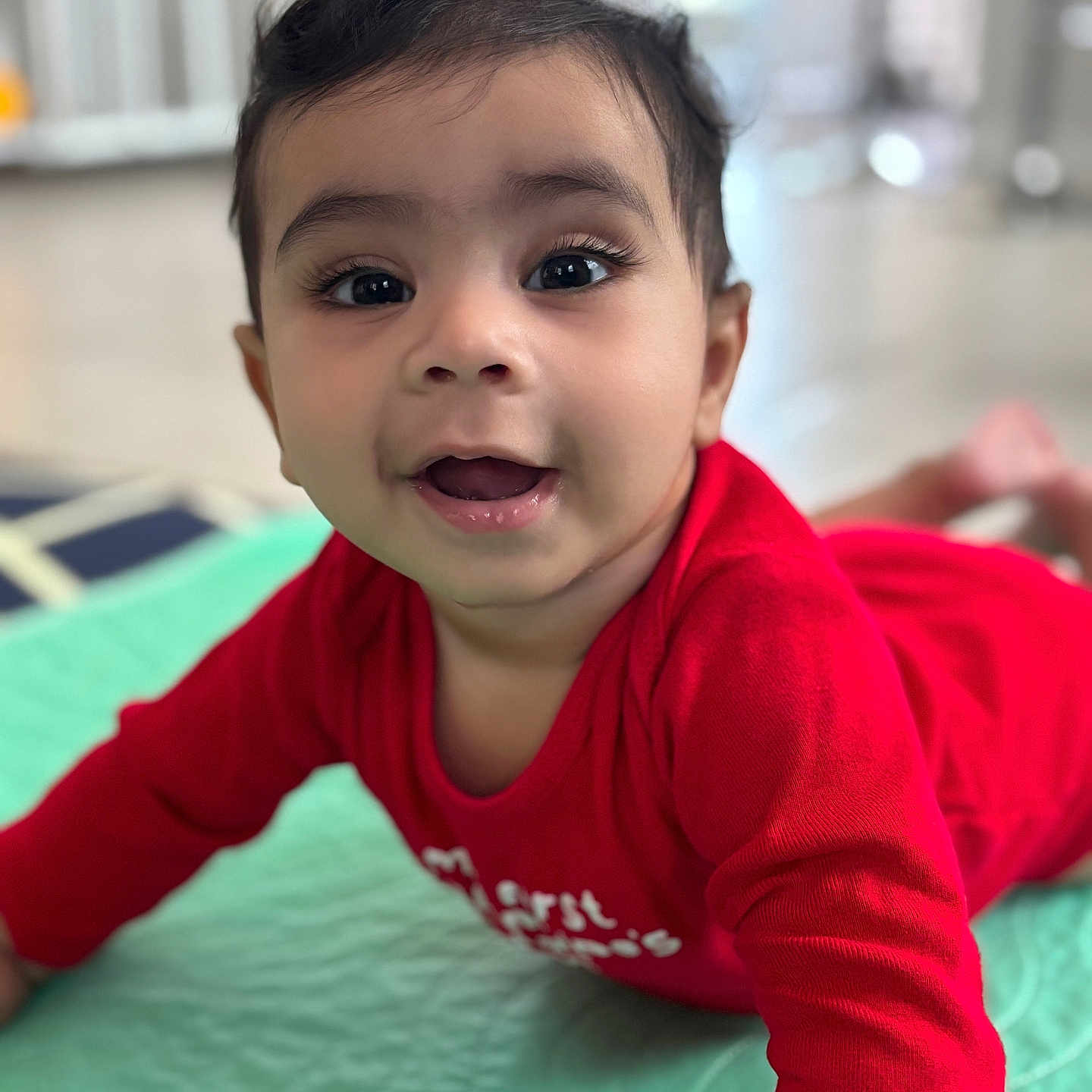 Vikrant Pillai is registered to the contest to win money with this photo: baby, blanket, child, closeup, cute, eyes, face, floor, hair, happy, indoor, infant, lying_down, mouth, person, portrait, quilt, red_clothing, skin, smiling