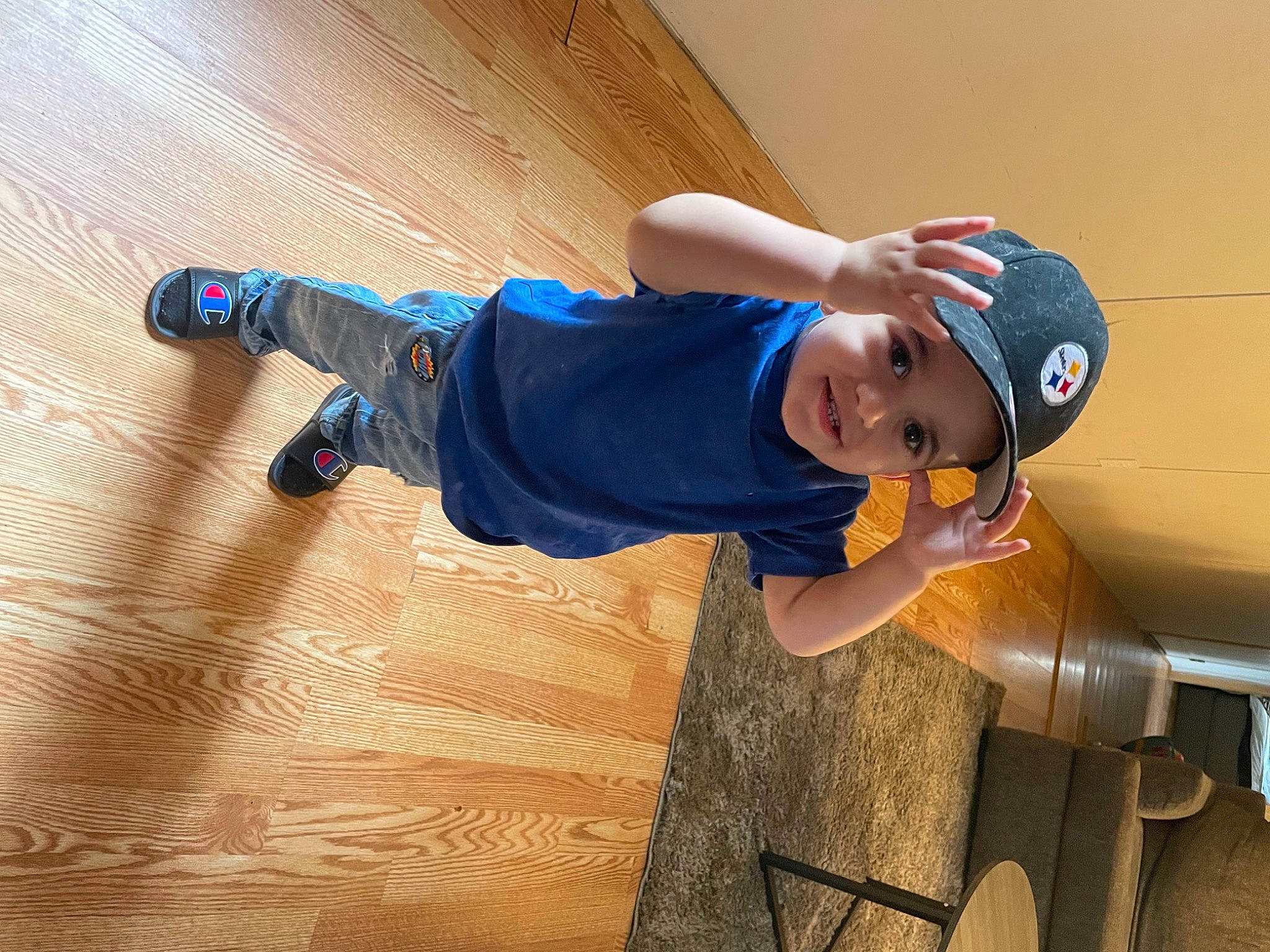 Dylan joined the competition — help win amazing prizes! baby_toddler_clothing, baseball_cap, child, cleanliness, electric_blue, flooring, fun, gas, hardwood, hat, headwear, leisure, person, smile, sneakers, sportswear, t_shirt, toddler, walking_shoe, wood
