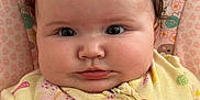 Pearl is registered to the contest to win money with this photo: baby, child, infant, face, eyes, onesie, butterfly, pattern, pink, yellow, floral, heart, cute, portrait, closeup, skin, hand, hair, indoor, soft