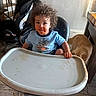 Thorin is registered to the contest to win money with this photo: toddler, child, high_chair, messy, food, curly_hair, cat, orange_cat, indoor, floor, staircase, painting, table, blue_shirt, foot, hand, face, expression, home, meal