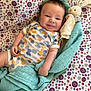 Mattéo a rejoint le concours — aidez-le/la à gagner de superbes lots ! baby, smiling, infant, blanket, plush_toy, bunny, colorful, pattern, clothing, fabric, cute, happy, portrait, lying_down, child, playful, soft, comfort, indoors, person