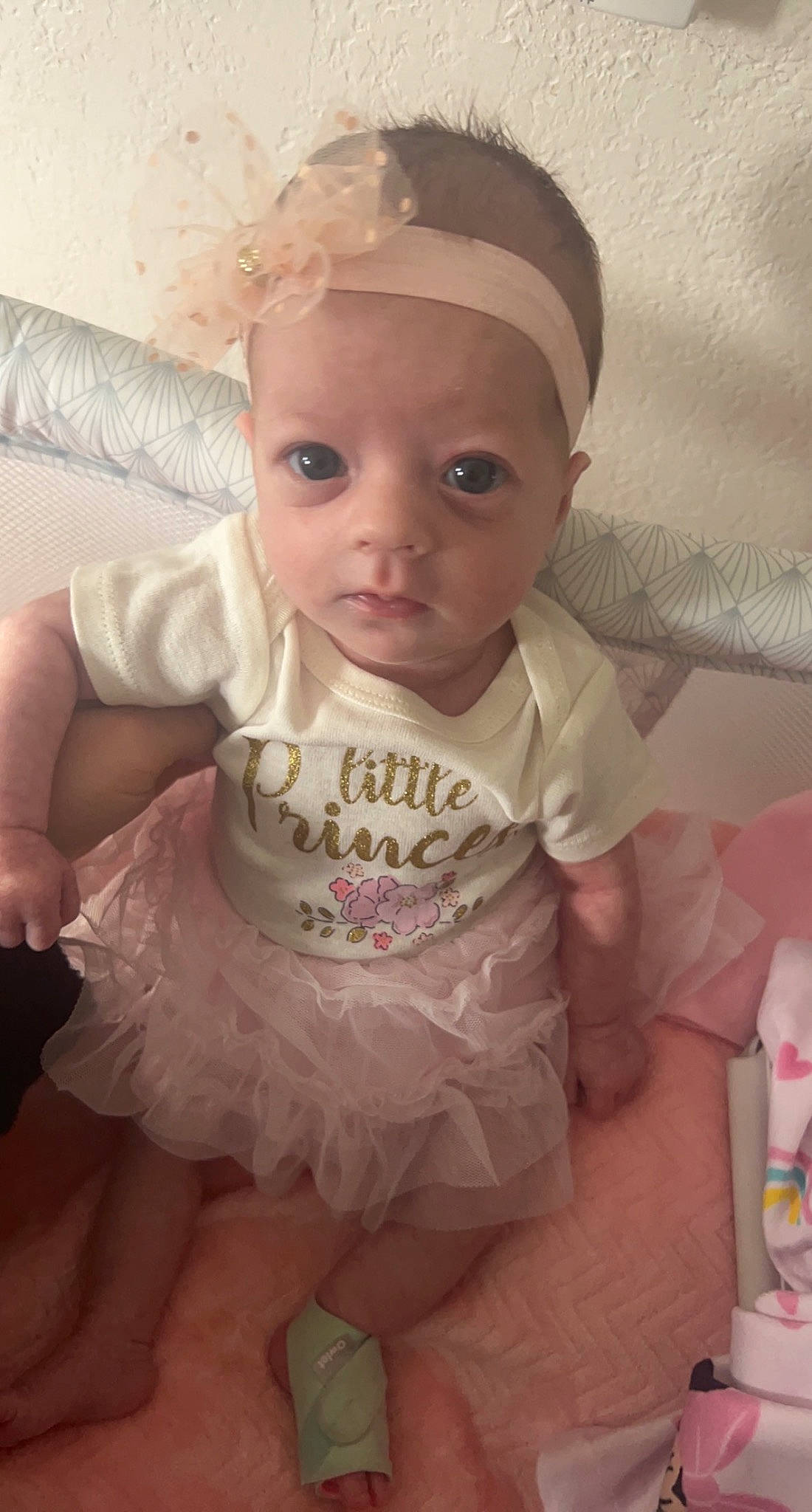 Elaina is registered to the contest to win money with this photo: arm, baby, baby_toddler_clothing, cap, cheek, day_dress, dress, eye, eyelash, happy, head, headgear, iris, lip, person, pink, skin, sleeve, textile, toddler