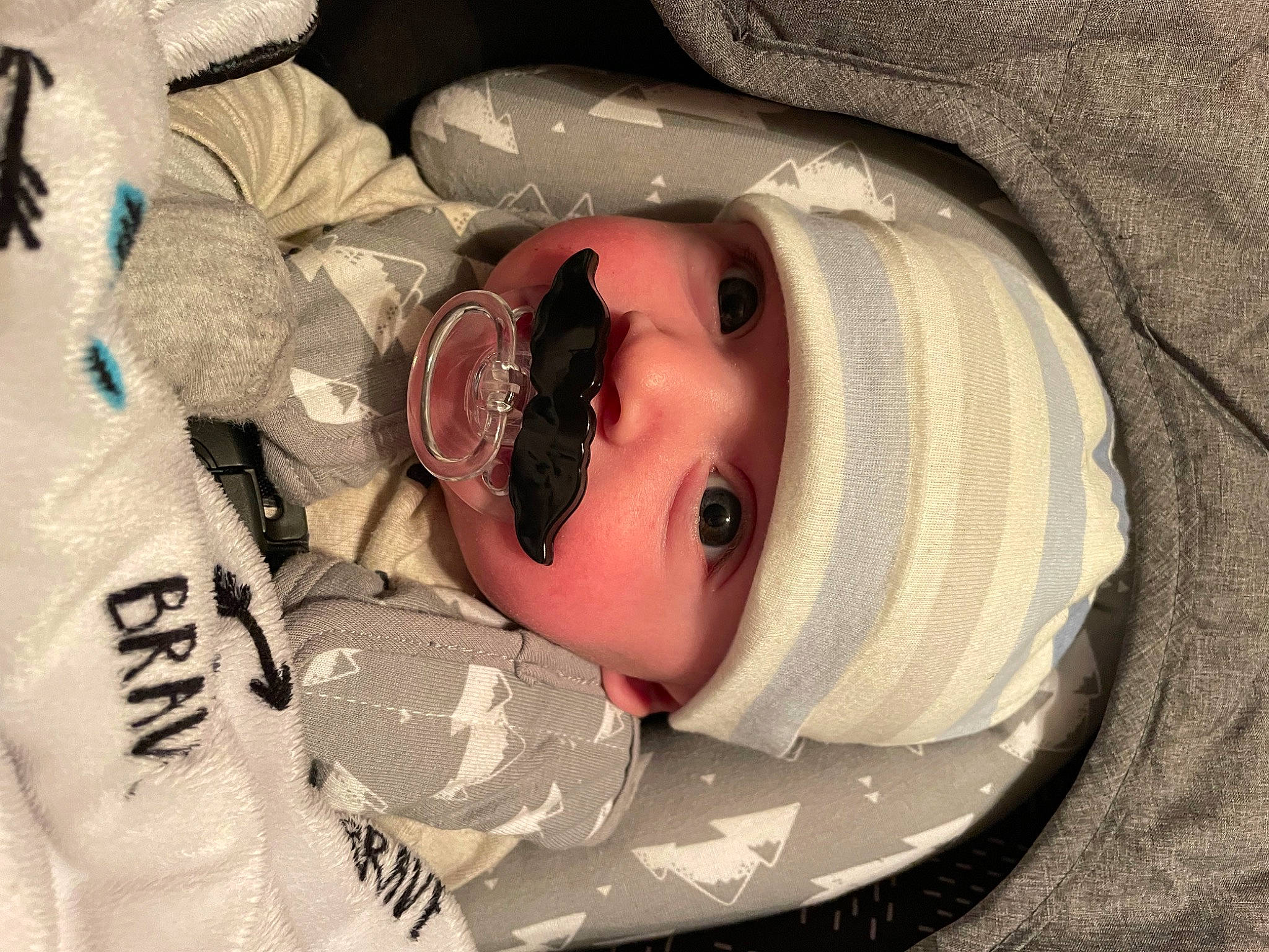 Knox is registered to the contest to win money with this photo: baby, baby_products, baby_toddler_clothing, cap, cheek, child, comfort, eye, eyelash, face, fashion_accessory, hat, head, headgear, headwear, lip, person, personal_protective_equipment, skin, smile