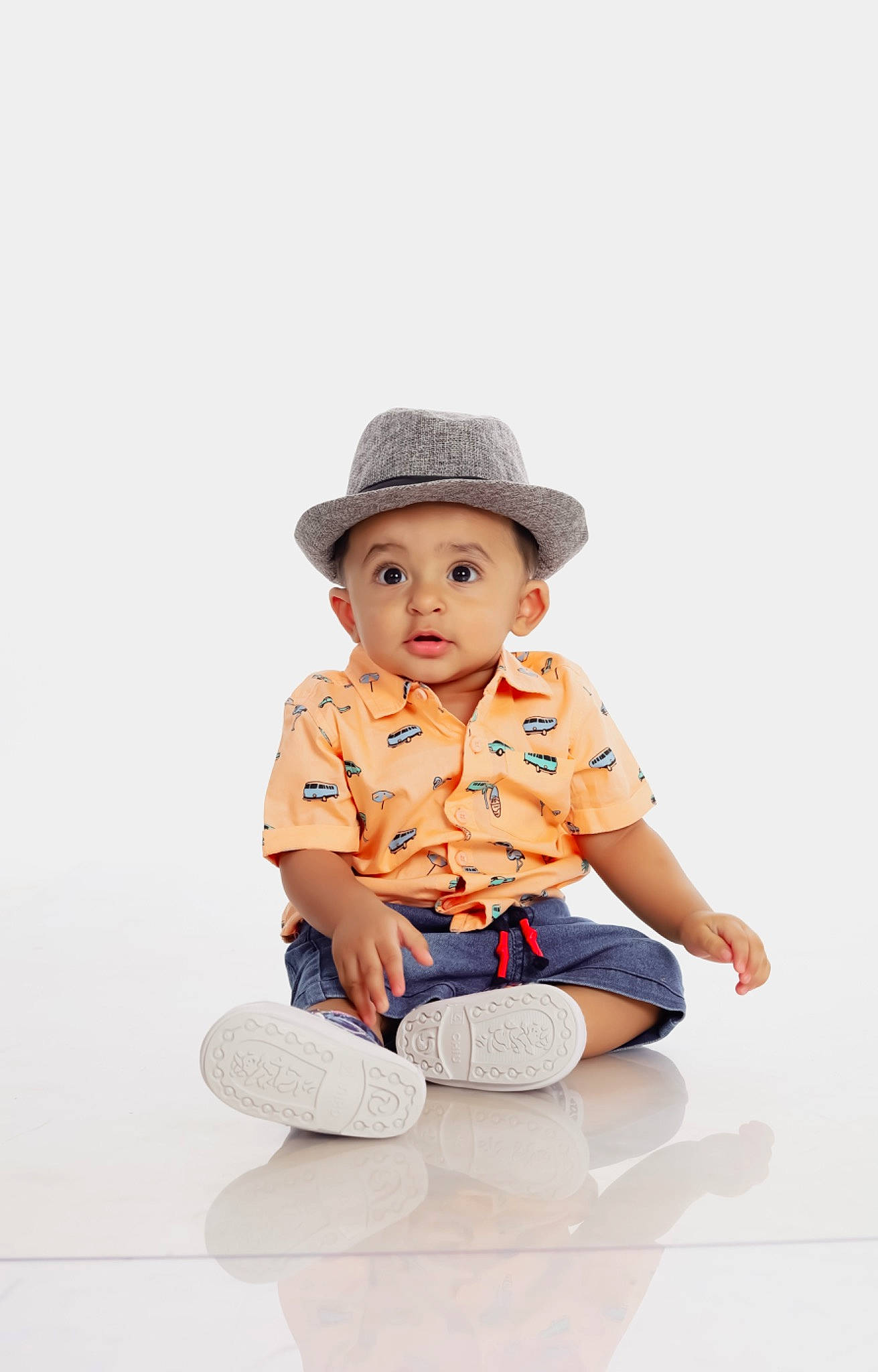 Avyaan is registered to the contest to win money with this photo: baby, baby_toddler_clothing, cap, child, collar, costume_hat, electric_blue, face, fashion_accessory, flash_photography, flooring, happy, hat, headwear, outerwear, pattern, person, product, sitting, sleeve