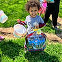 King joined the competition — help win amazing prizes! child, smiling, curly_hair, easter_basket, bucket, grass, outdoor, sunny, happy, toy, play, kids, festival, spring, daylight, event, celebration, holding, person, fun