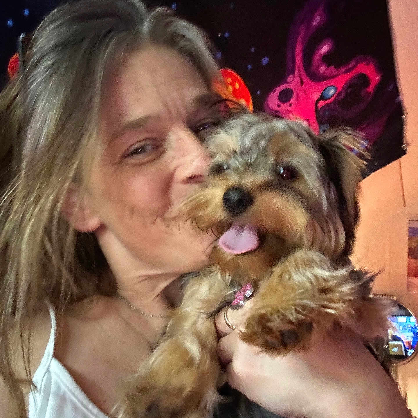 Arbi is registered to the contest to win money with this photo: casual, closeup, colorful, cosmic, cuddling, dog, face, fur, hair, hand, happy, indoor, pet, portrait, room, smiling, tank_top, tapestry, tongue, woman