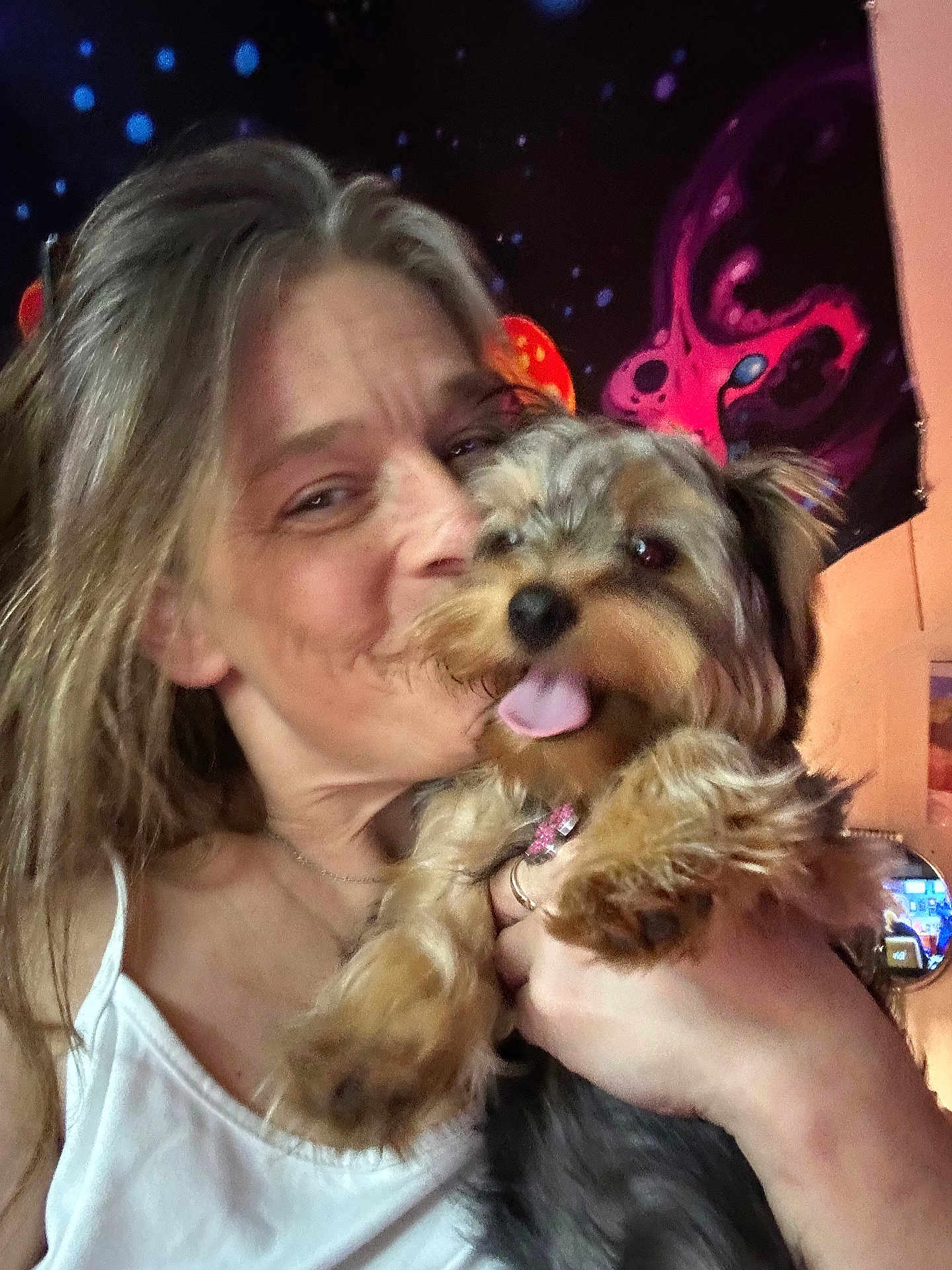 Arbi is registered to the contest to win money with this photo: casual, closeup, colorful, cosmic, cuddling, dog, face, fur, hair, hand, happy, indoor, pet, portrait, room, smiling, tank_top, tapestry, tongue, woman