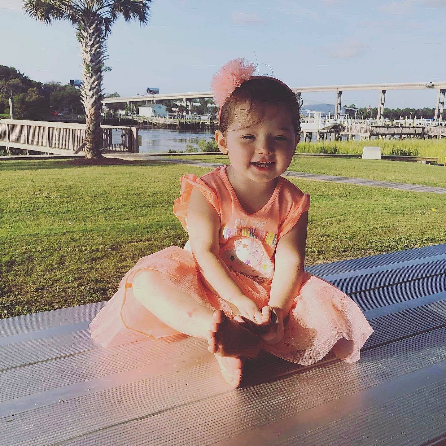 Amara joined the competition — help win amazing prizes! baby, baby_toddler_clothing, barefoot, dress, eye, face, fun, grass, happy, head, leg, leisure, person, plant, recreation, skin, sky, smile, summer, toddler