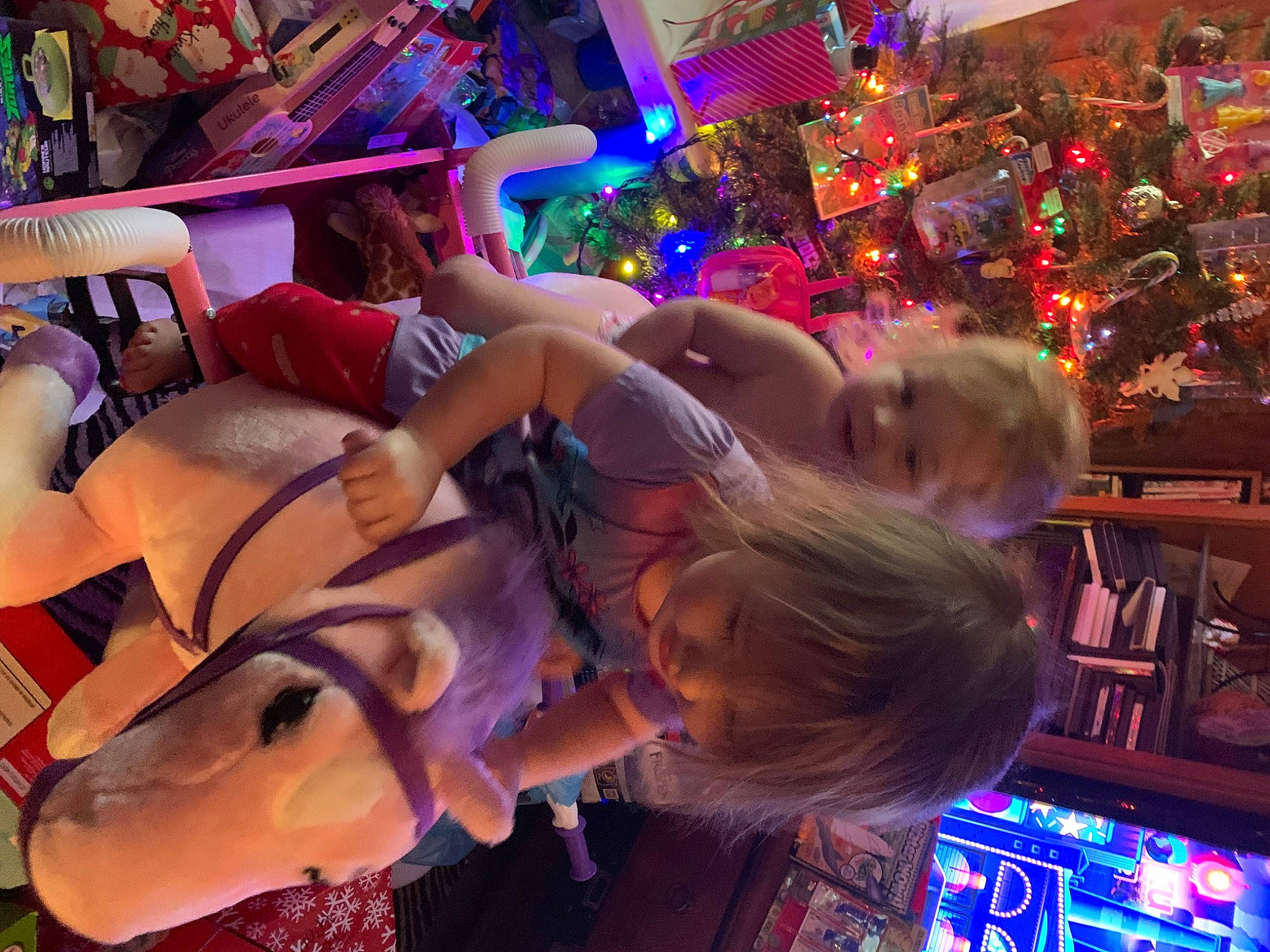 John is registered to the contest to win money with this photo: child, christmas_ornament, city, entertainment, event, festival, fun, holiday, leisure, light, magenta, night, ornament, person, pink, plant, purple, recreation, toddler, tree