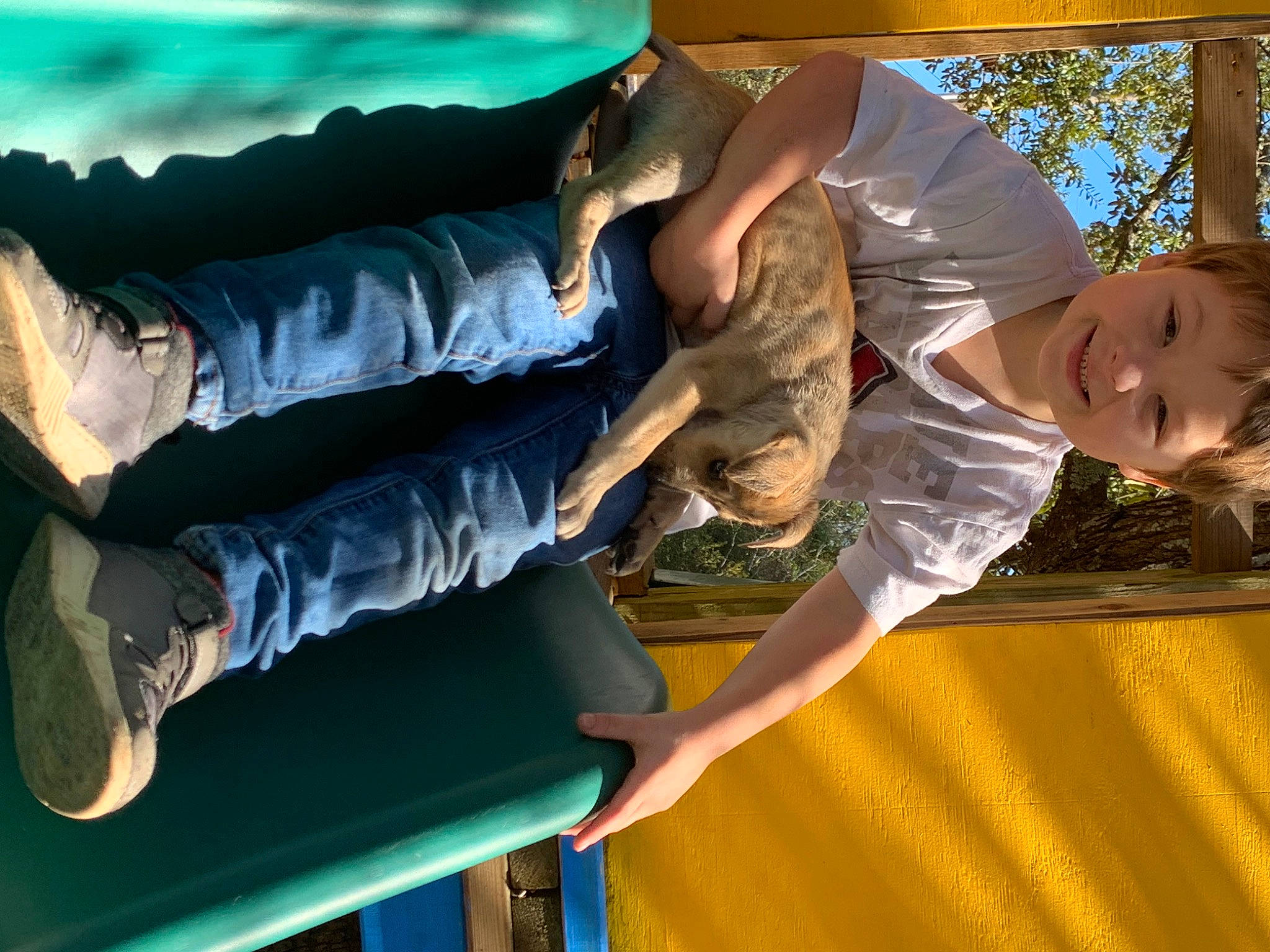 John is registered to the contest to win money with this photo: comfort, elbow, fun, grass, happy, human_leg, joint, joy, knee, leg, leisure, person, recreation, shoe, smile, snapshot, sneakers, thigh, toddler, trampolining_equipment_and_supplies