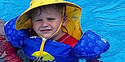 Colton joined the competition — help win amazing prizes! child, pool, water, yellow_hat, floaties, swimming, summer, outdoor, fun, blue, red_shirt, splash, sun_hat, boy, safety, swim_aid, wet, play, recreation, leisure