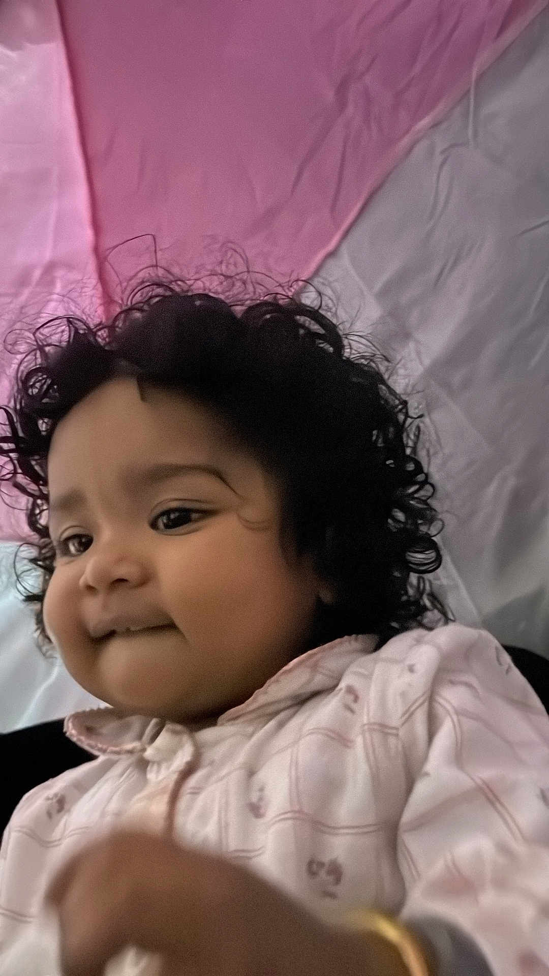 Japnaaz joined the competition — help win amazing prizes! child, toddler, curly_hair, jacket, pink_background, white_background, close_up, portrait, indoor, cute, baby, person, smile, face, hand, soft_light, casual_clothing, young_child, expression, warm_colors