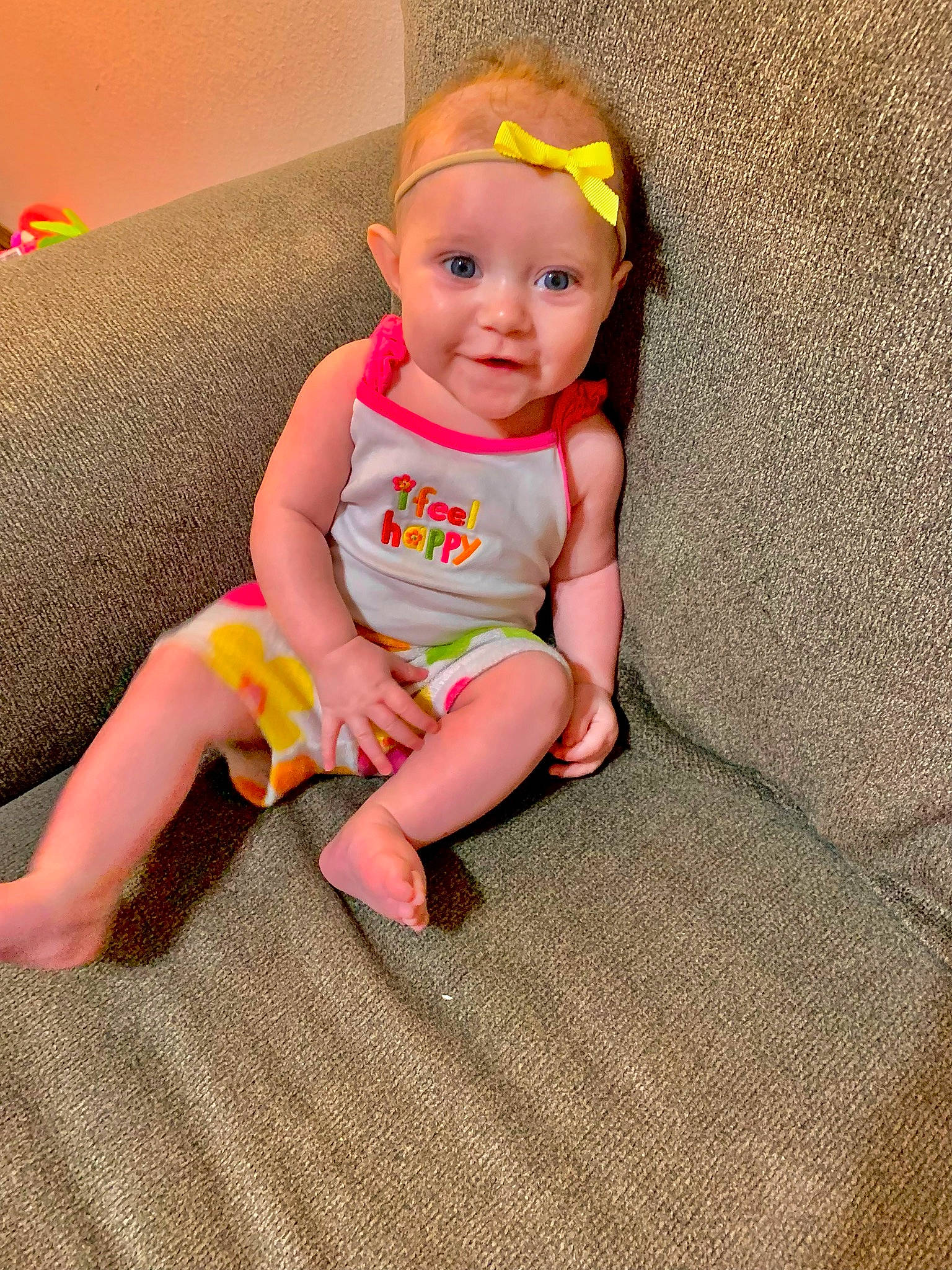 Elianna is registered to the contest to win money with this photo: baby, baby_toddler_clothing, cheek, comfort, eye, face, finger, floor, flooring, foot, fun, happy, head, knee, orange, person, pink, skin, smile, thigh