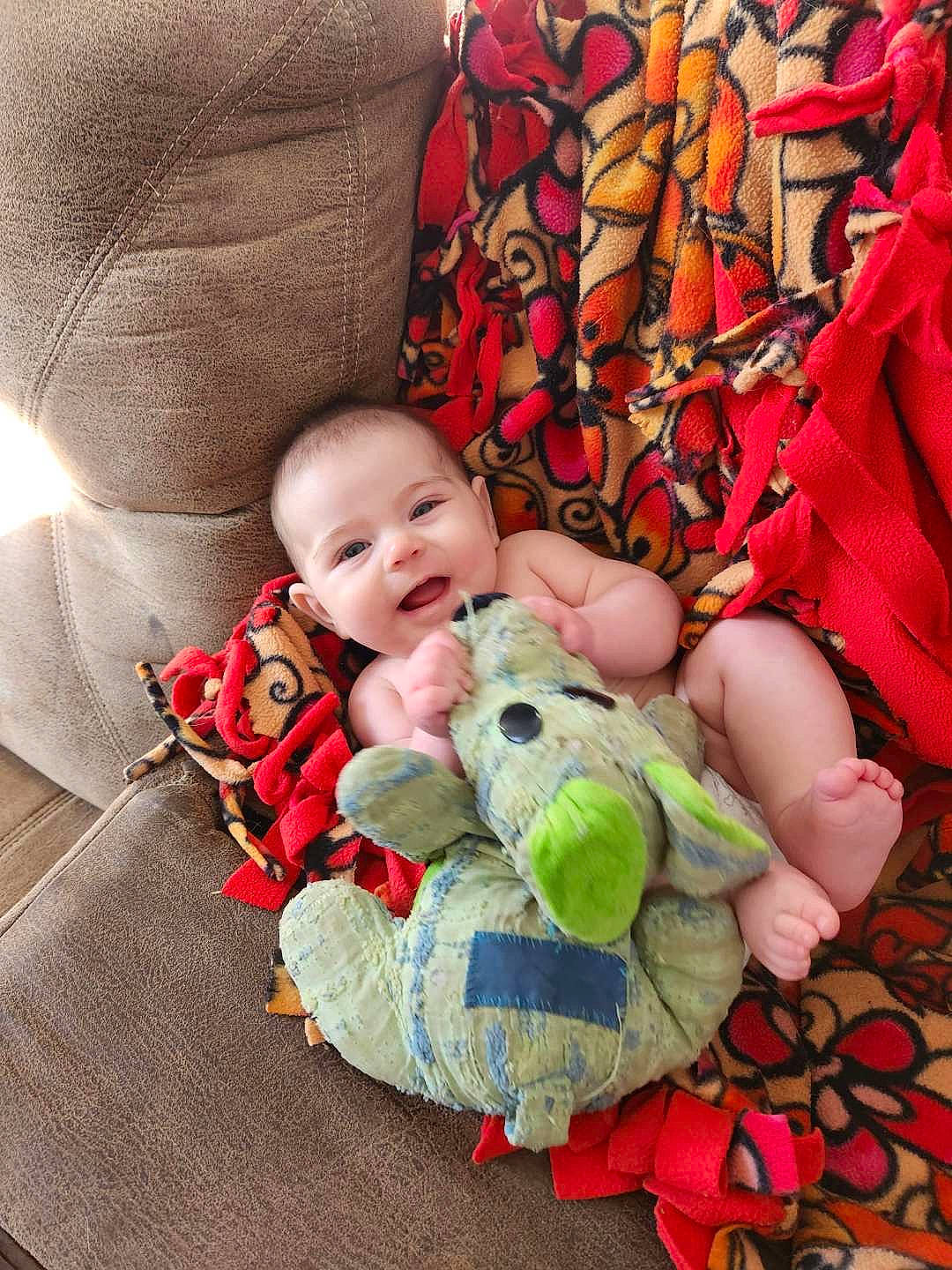 Maisie joined the competition — help win amazing prizes! baby, baby_products, baby_toddler_clothing, bedding, bedtime, cheek, child, comfort, happy, human, linens, pattern, person, room, sitting, skin, smile, stuffed_toy, textile, toddler