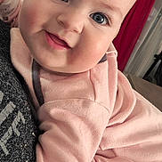 Océane a rejoint le concours — aidez-le/la à gagner de superbes lots ! baby, smiling, close_up, blue_eyes, pink_clothing, infant, indoors, portrait, cute, child, face, hair, happy, soft_lighting, cozy, blanket, couch, person, toddler, warm