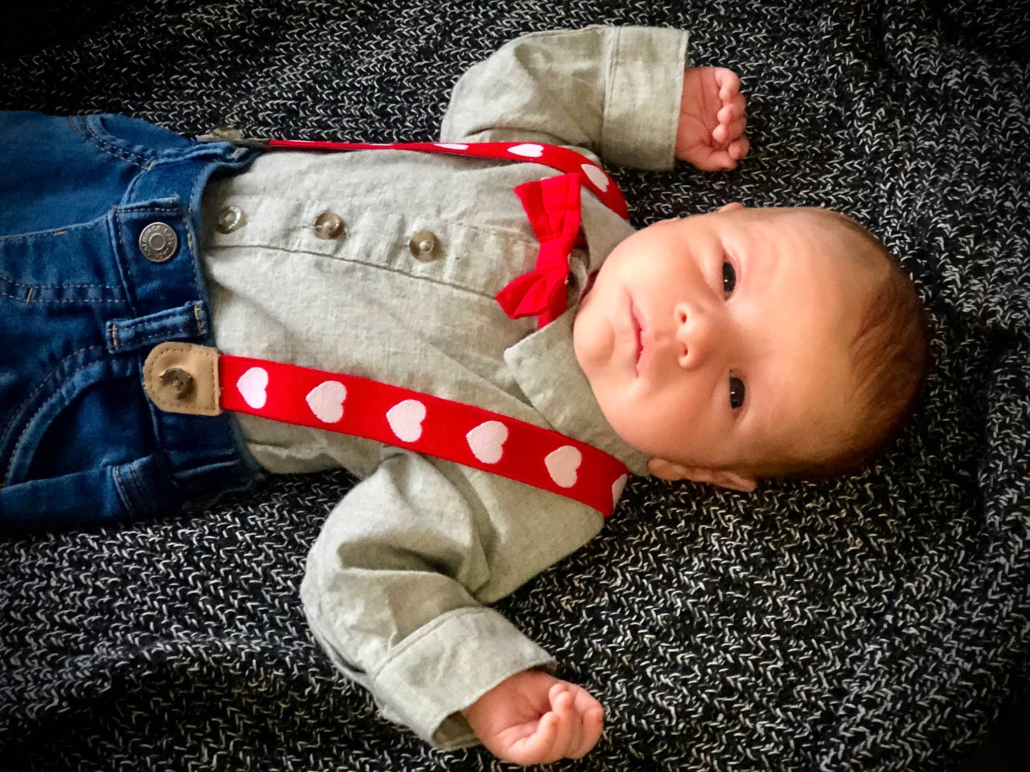 Killian is registered to the contest to win money with this photo: baby, baby_toddler_clothing, carmine, cheek, child, comfort, eye, face, happy, hat, head, lip, nose, pattern, person, sitting, skin, sleeve, smile, toddler