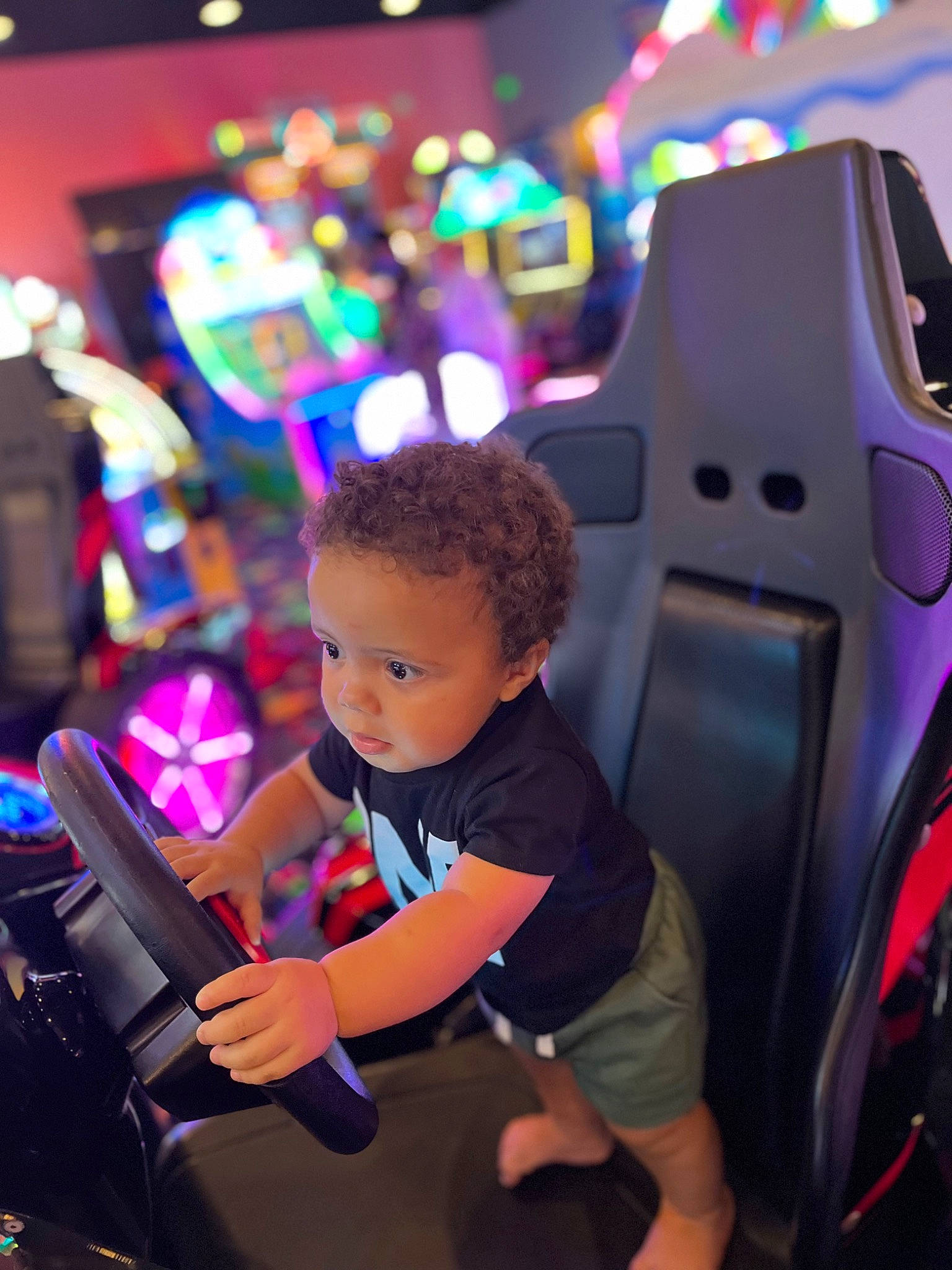 Zyaire is registered to the contest to win money with this photo: audio_equipment, automotive_design, child, city, entertainment, event, fun, games, leisure, machine, magenta, person, play, purple, recreation, sitting, snapshot, t_shirt, technology, toddler