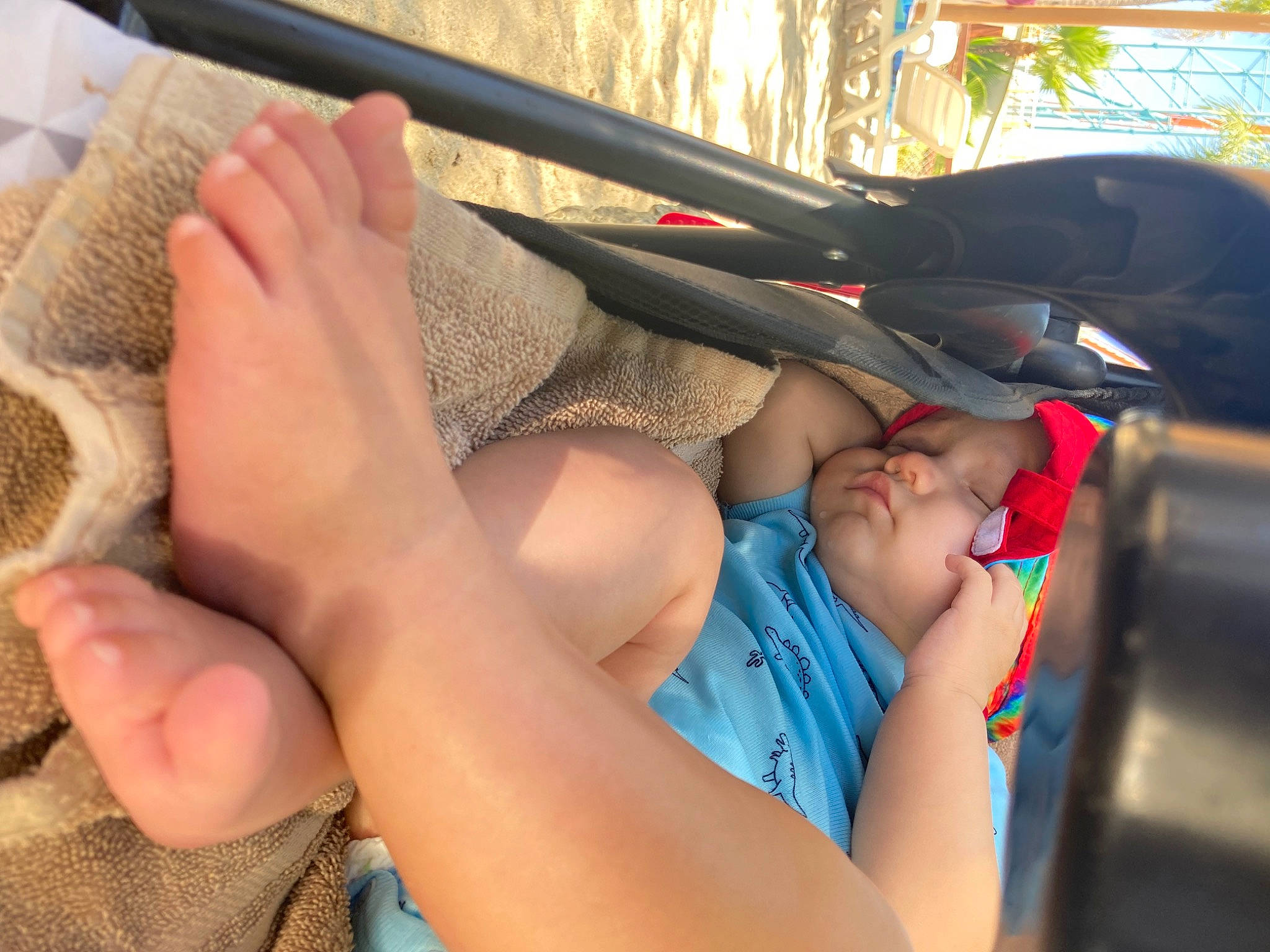 Asher is registered to the contest to win money with this photo: auto_part, automotive_exterior, barefoot, child, comfort, elbow, finger, foot, fun, hat, human_leg, knee, leg, leisure, nail, person, recreation, shorts, steering_wheel, thigh