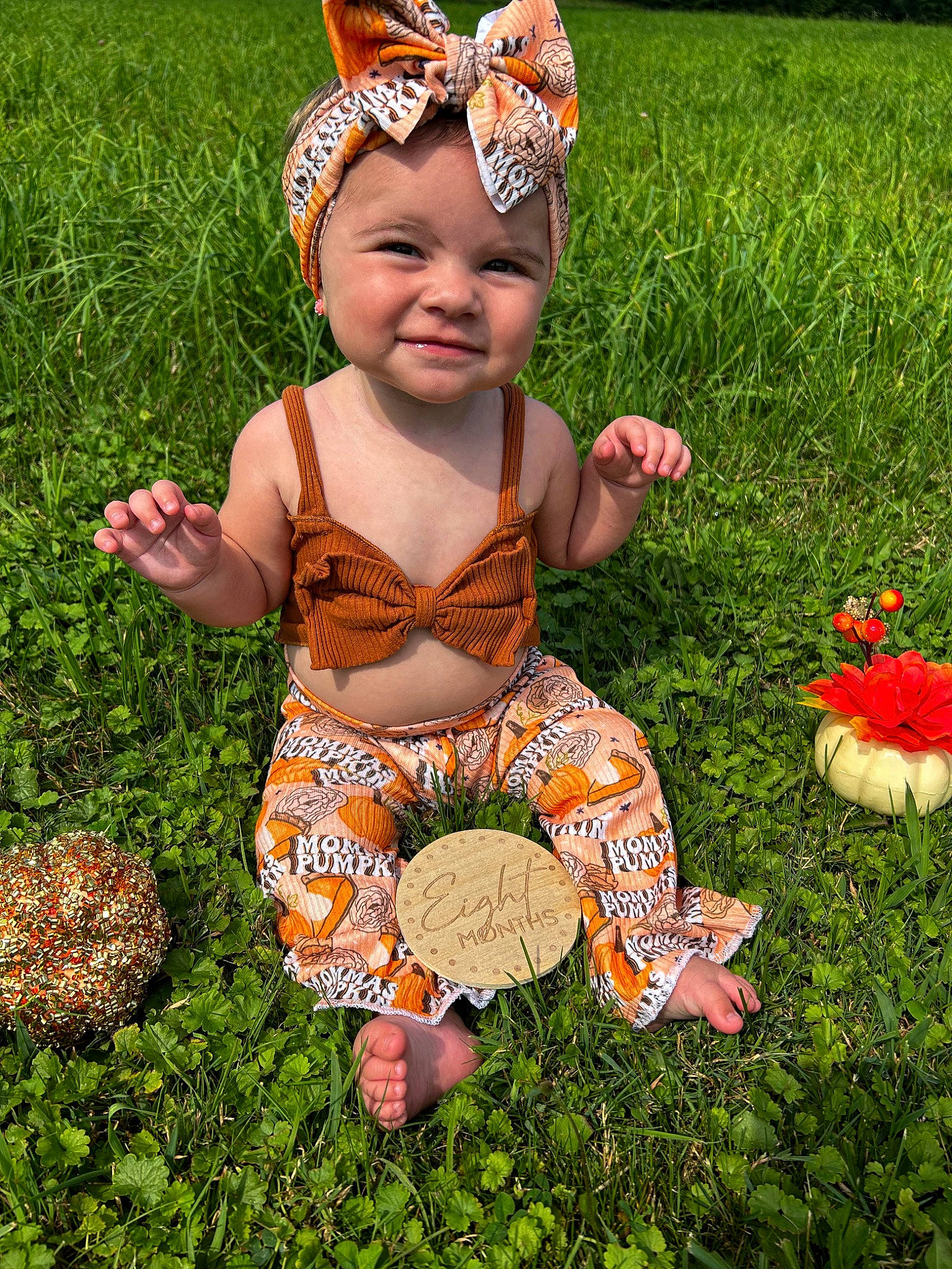 Aryah is registered to the contest to win money with this photo: baby, baby_toddler_clothing, botany, costume_hat, flower, fun, grass, grass_family, green, happy, headwear, joy, lawn, leaf, mammal, meadow, people_in_nature, person, plant, smile