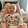 Thomas is registered to the contest to win money with this photo: baby, infant, smile, onesie, animal_print, legs, diaper, indoor, bedroom, person, happy, cute, soft_light, portrait, child, skin, clothing, face, sitting, comfort