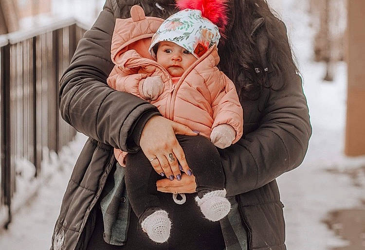 Lyana participe au concours pour gagner de l'argent avec cette photo : cap, event, freezing, fun, fur, gesture, happy, headgear, headwear, hood, hug, jacket, knit_cap, leisure, outerwear, person, sitting, sleeve, snow, street_fashion