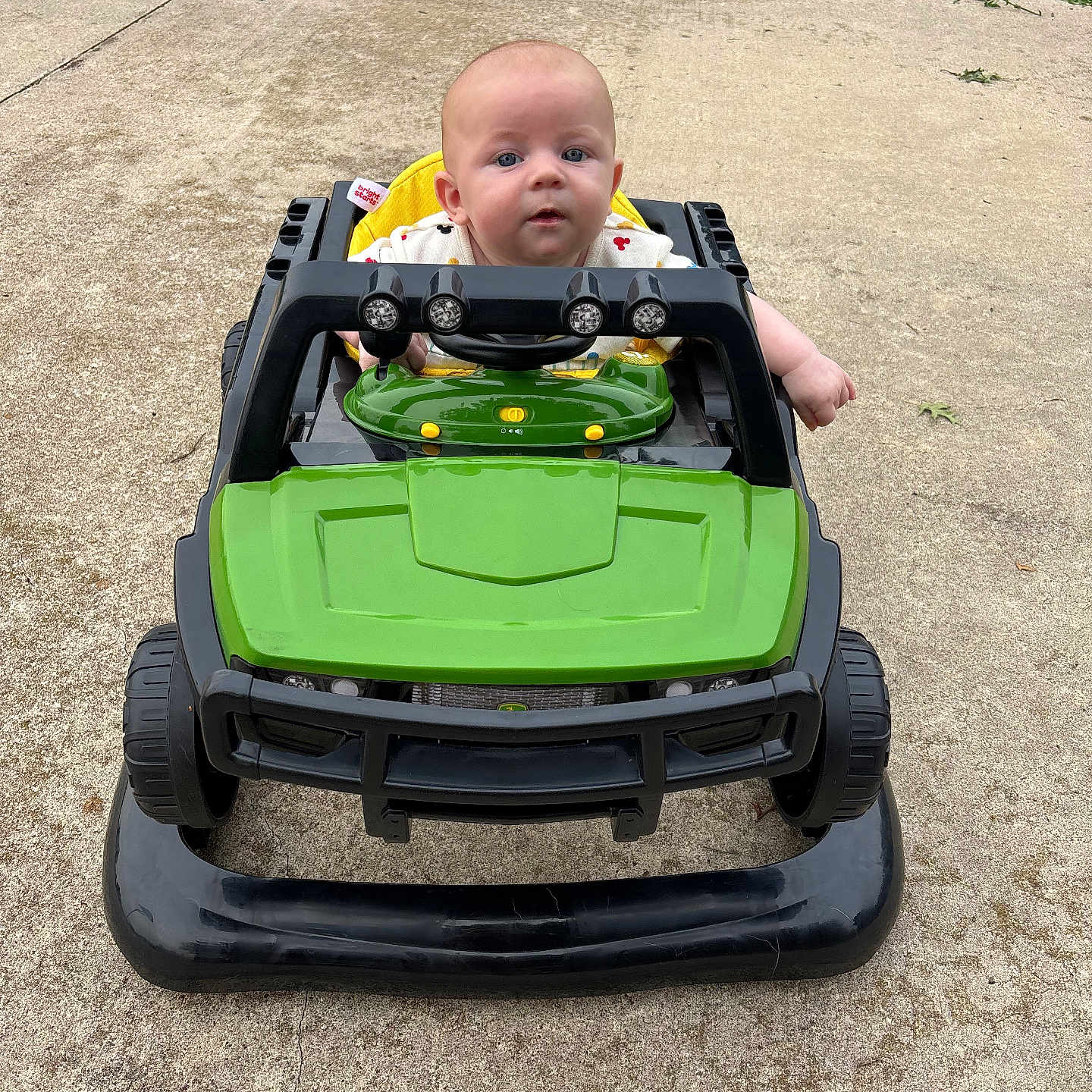 Oliver Lee is registered to the contest to win money with this photo: baby, blue_eyes, child, clothing, concrete, curious, daylight, face, grass, green, hand, head, infant, outdoor, play, seat, toy_car, vehicle, wheel, young_child