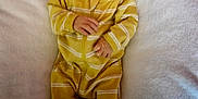 Oliver Lee joined the competition — help win amazing prizes! baby, bed, blanket, cute, face, footed_pajamas, head, human, indoors, infant, lying_down, newborn, onesie, portrait, resting, sleepwear, small_hands, soft_texture, striped_clothing, yellow_clothing