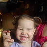 Isabella is registered to the contest to win money with this photo: child, toddler, smile, happy, face, pigtails, person, indoor, clothing, purple_shirt, pink_shirt, hand, expression, cute, young, portrait, baby, person_holding_child, blurred_background, light