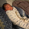 Malachi is registered to the contest to win money with this photo: baby, bed, bedroom, blanket, child, cozy, eyes_open, face, indoor, infant, knitted_blanket, lying_down, pacifier, pacifier_clip, patterned_clothing, pillow, portrait, sleepwear, soft_lighting, swaddled