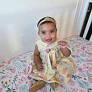 Alaia joined the competition — help win amazing prizes! baby, child, smiling, dress, headband, sitting, bed, floral_pattern, butterfly_pattern, golden_shoes, ribbon, happy, indoors, cute, portrait, infant, colorful, person, fabric, decor