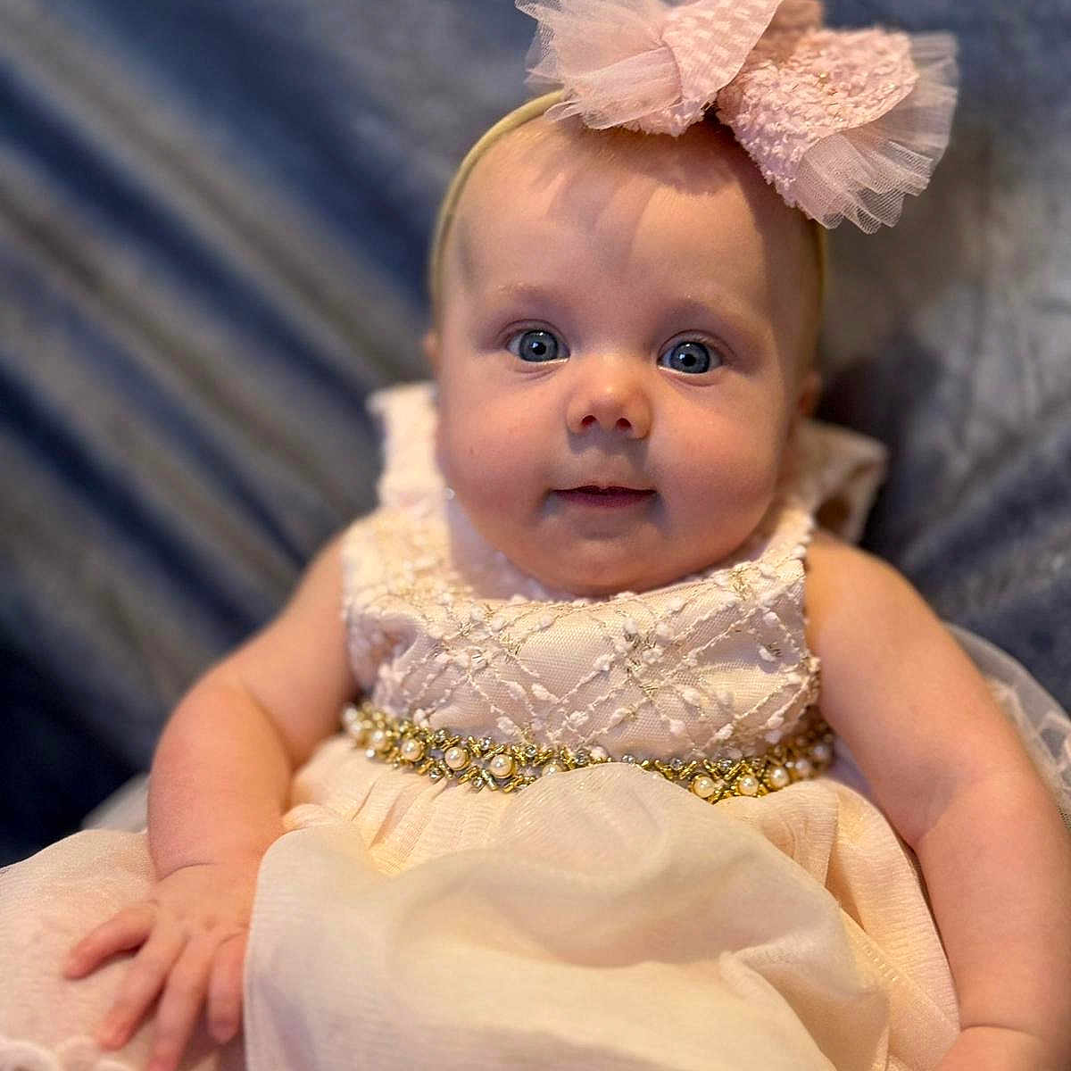 Violet joined the competition — help win amazing prizes! baby, blue_eyes, bow, child, clothing, cute, cute_face, dress, fabric, hand, headband, indoors, infant, person, portrait, sitting, smile, soft_background, texture, young