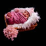 newborn, baby, pink, blanket, hat, wicker_basket, fluffy, white_fur, flowers, pink_flowers, smiling, sleeping, cute, portrait, infant, wrapped, cozy, soft_texture, dark_background, studio_photo