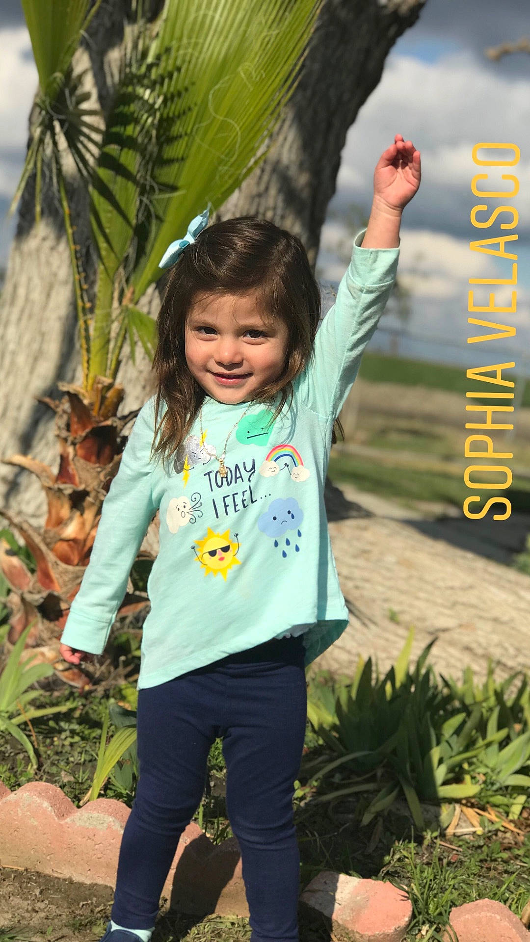 Sophia Velasco is registered to the contest to win money with this photo: child, day, facial_expression, fun, girl, grass, green, happiness, jeans, joy, leisure, outerwear, person, plant, play, product, recreation, smile, toddler, tree