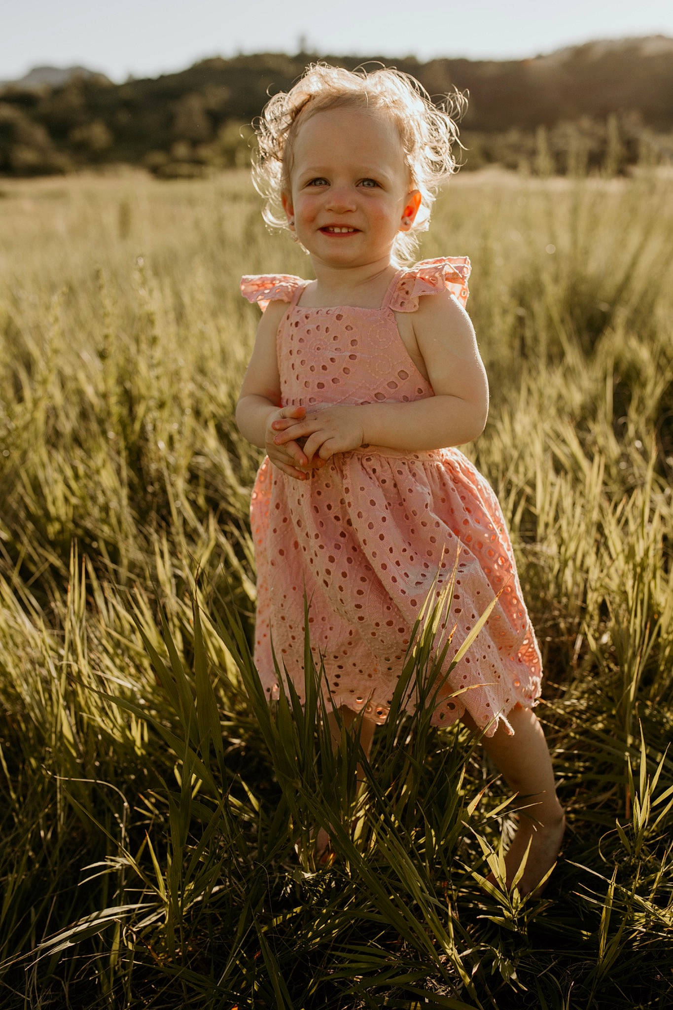 Eleanor is registered to the contest to win money with this photo: baby_toddler_clothing, clothing, day_dress, dress, ecoregion, flash_photography, fun, grass, grassland, happy, head, joy, people_in_nature, person, photograph, plant, sky, smile, standing, summer