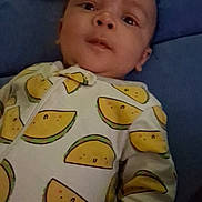 Kylo is registered to the contest to win money with this photo: baby, infant, child, face, onesie, clothing, pattern, watermelon, blanket, blue, lying_down, expression, cute, young, portrait, indoor, person, head, skin, small