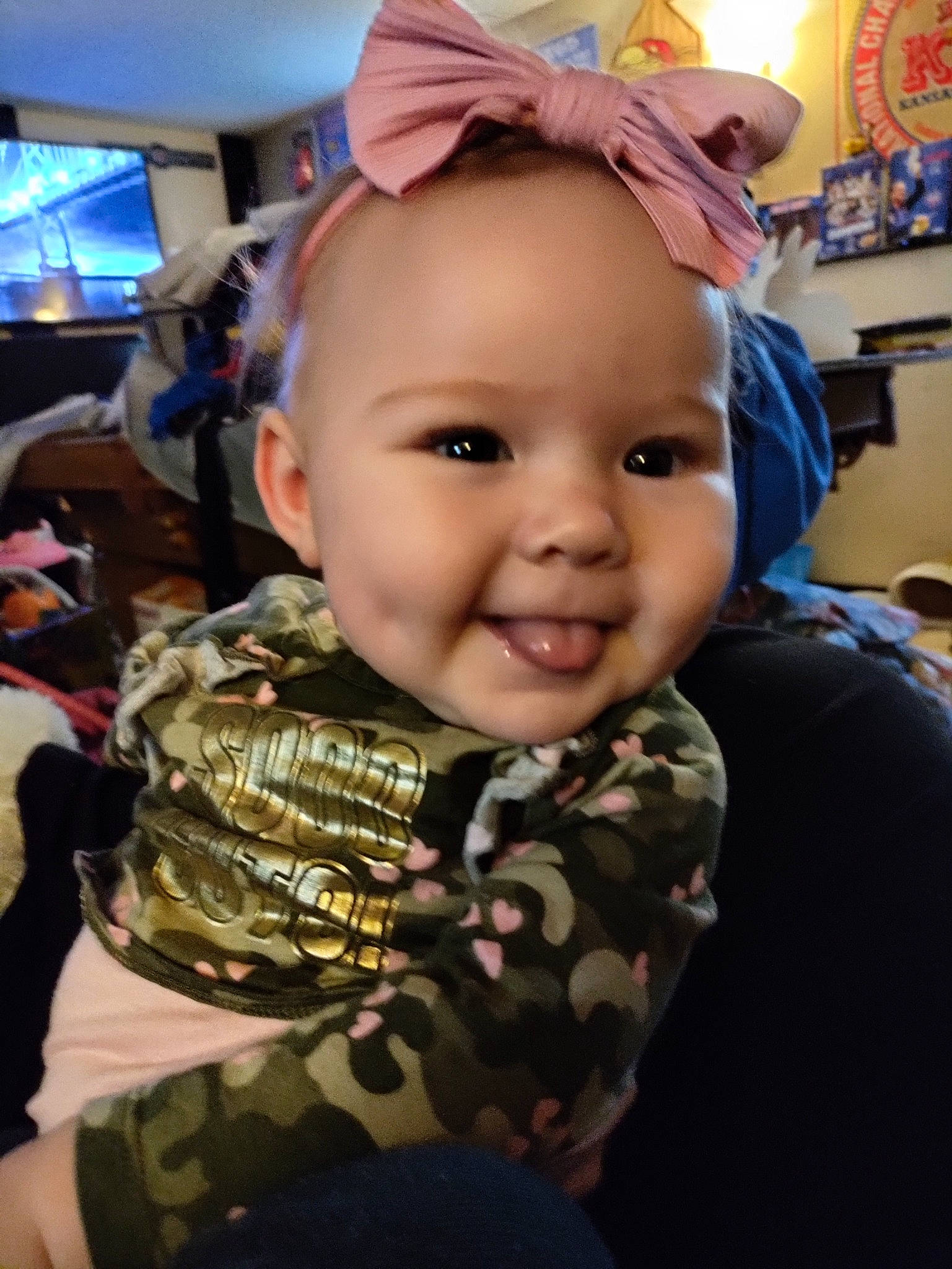 Holly is registered to the contest to win money with this photo: baby, cheek, child, cool, ear, event, eyelash, fashion_accessory, fun, happy, iris, joy, person, personal_protective_equipment, room, sitting, skin, smile, television, textile