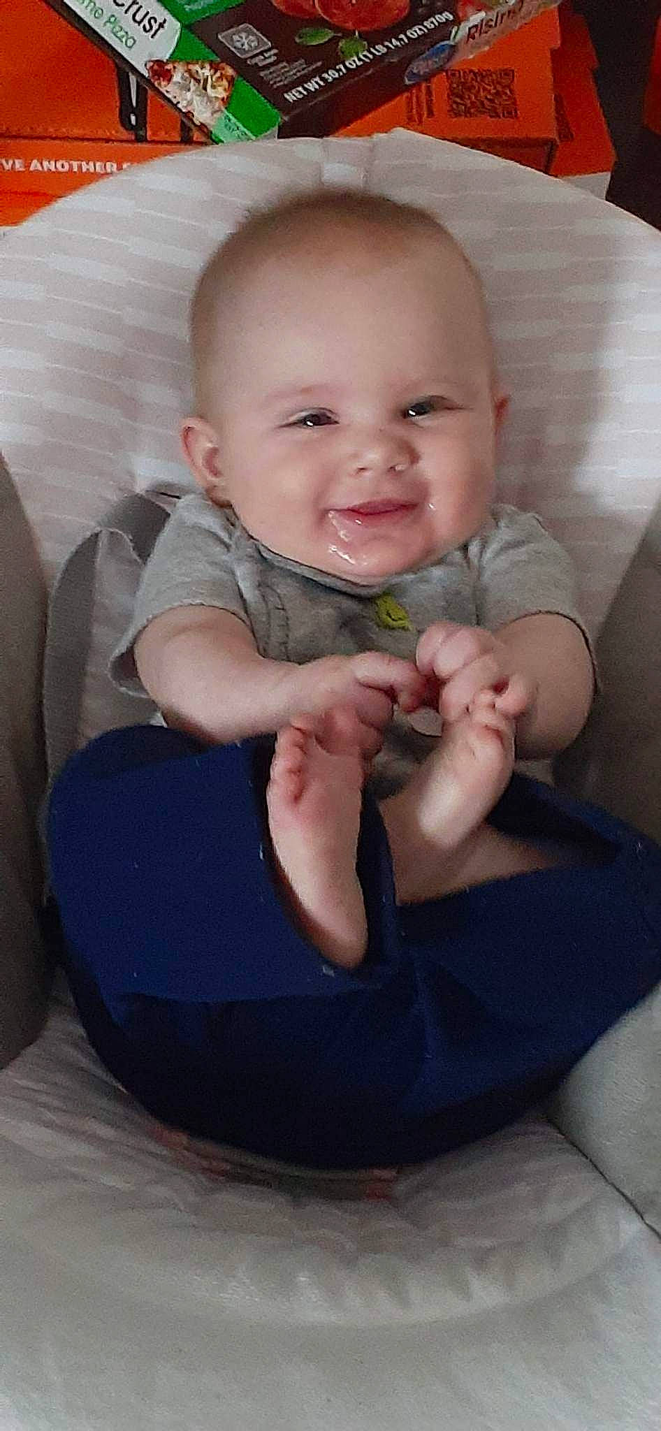 Lilith is registered to the contest to win money with this photo: baby, baby_toddler_clothing, cheek, child, chin, comfort, finger, fun, gesture, hand, happy, joy, lap, leg, mouth, nail, person, skin, sleeve, smile